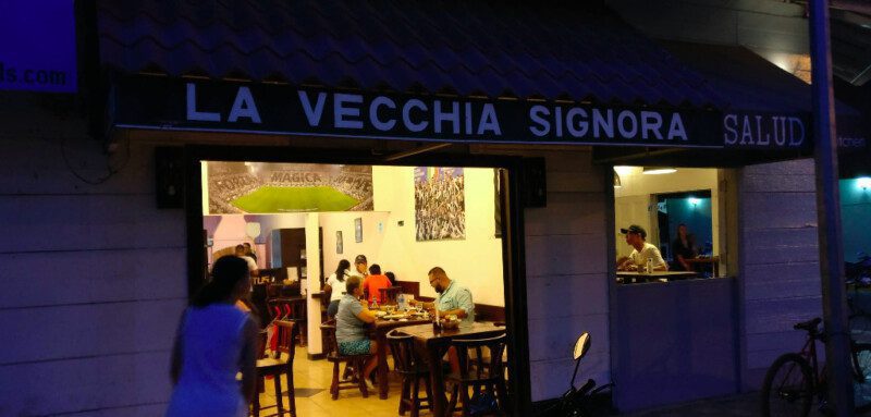 Wood-fired pizza fresh from the oven at Pizzería La Vecchia Signora, served in a cozy Italian-style setting in downtown San Juan del Sur, Nicaragua