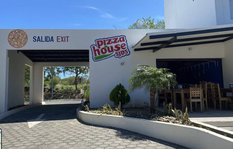 Freshly baked pizzas and cozy dining ambiance at Pizza House SJDS, located in the heart of San Juan del Sur, Nicaragua