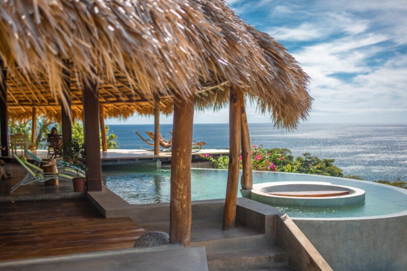 Clifftop infinity pool and restaurant at Hush Maderas overlooking Playa Maderas, San Juan del Sur