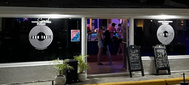 Interior of TurnTable SJDS showcasing vibrant ambiance and patrons enjoying tapas and cocktails in San Juan del Sur, Nicaragua