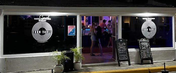 Interior of TurnTable SJDS showcasing vibrant ambiance and patrons enjoying tapas and cocktails in San Juan del Sur, Nicaragua