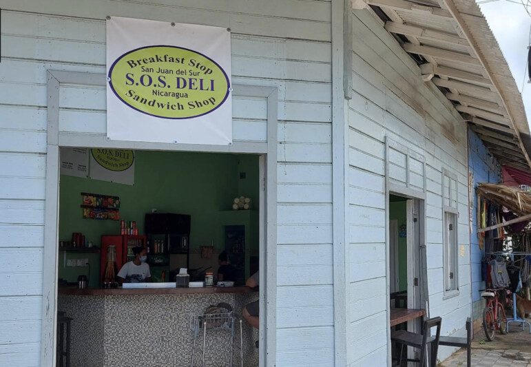 Exterior view of SOS Deli in San Juan del Sur, showcasing its inviting entrance and signage
