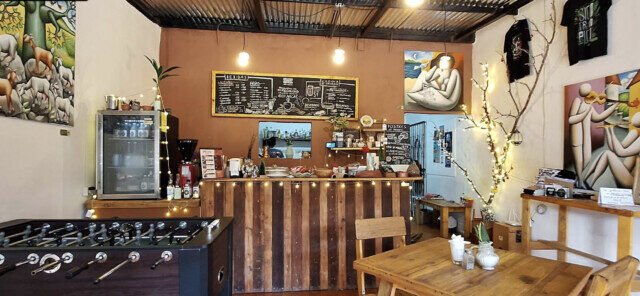 nterior of ORIGEN Gallery & Coffee Shop in San Juan del Sur, featuring Nicaraguan artwork, handmade products, and cozy café seating.
