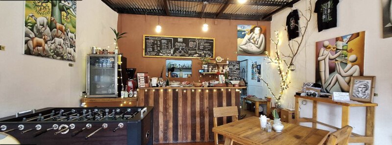 nterior of ORIGEN Gallery & Coffee Shop in San Juan del Sur, featuring Nicaraguan artwork, handmade products, and cozy café seating.