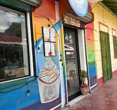 "Interior of Beta Fro-Yo showcasing a variety of frozen yogurt flavors and toppings in San Juan del Sur, Nicaragua