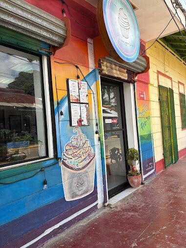 "Interior of Beta Fro-Yo showcasing a variety of frozen yogurt flavors and toppings in San Juan del Sur, Nicaragua