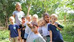 Outdoor classroom at San Juan del Sur Day School with students engaged in nature-based learning activities on the farm campus