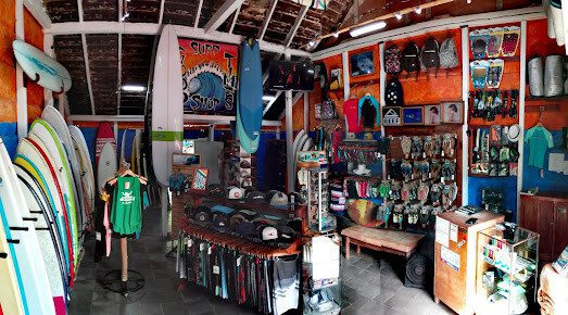 Surfboards displayed outside Good Times Surf Shop in San Juan Del Sur with colorful beach gear and clothing