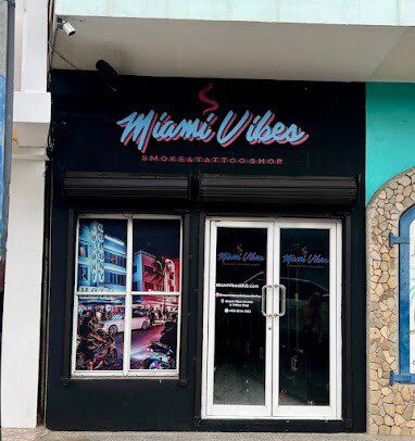 A vibrant tattoo session taking place inside Miami Vibes Smoke And Tattoo Shop in San Juan Del Sur