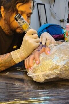 A tattoo and piercing artist working inside Papayas Ink in San Juan Del Sur, Nicaragua