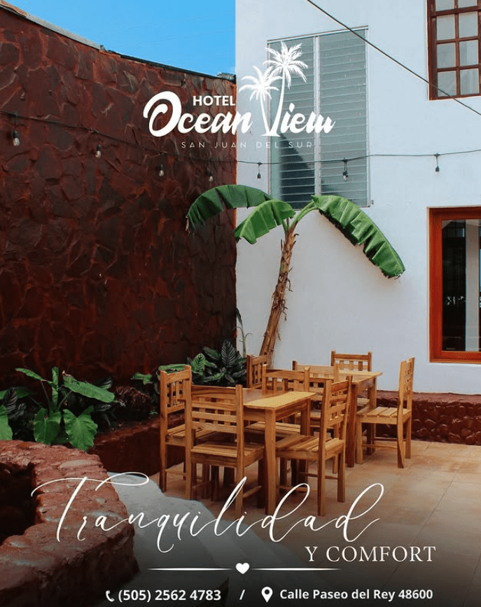 Image of outside walled area at Hotel Ocean View with tables and chairs