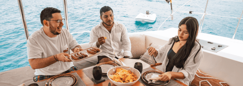 Santana Sail image of a catermaran with guests enjoying grilled meats on the ocean