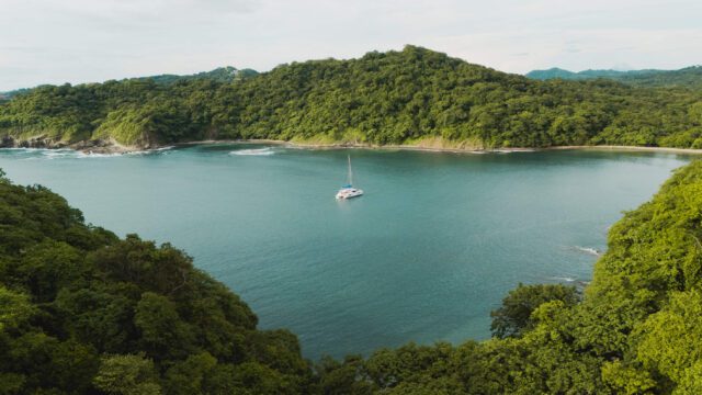 Overhead View of the Yacht from a Distance Bordered by Hills Santana Sail